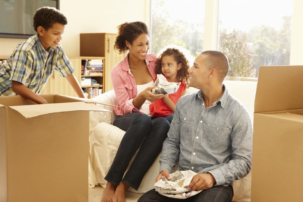 a happy family moving into a house